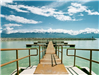 Dock Area On Lake With Mountain Range in Background