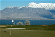 Golf Course With Large Lake in the Background and Mountain Range