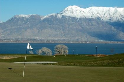 Golf Course With Large Lake in the Background and Mountain Range