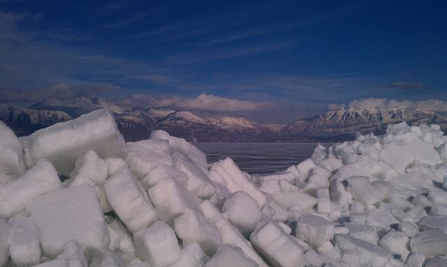 Snowy Mount Near Lake With Mountains in the Background