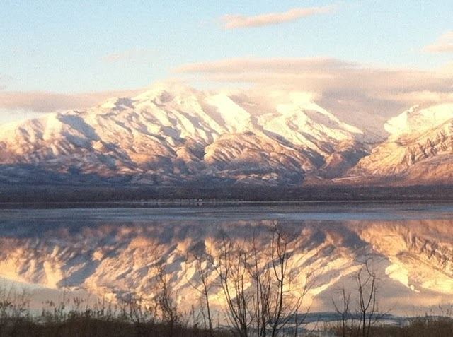 Snowy Mountain Range In Background of Lake Area